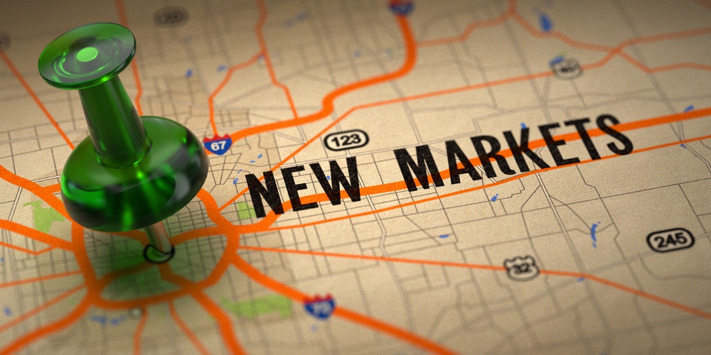 New Markets Concept - Green Pushpin on a Map Background with Selective Focus.-1